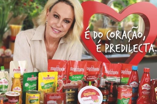 Ana Maria Braga e produtos Predilecta. Ela representa o carinho, amor e acolhimento que o grupo tem com colaboradores, parceiros do campo, fornecedores e consumidores